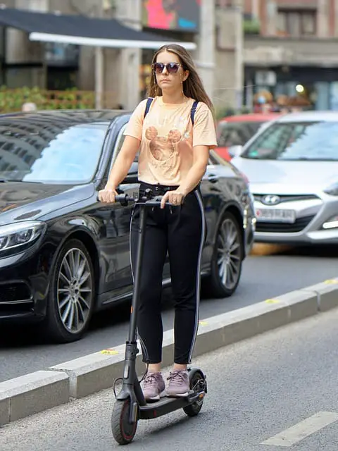 woman riding electric scooter